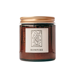 Bonfire candle in amber jar with gold lid for wholesale through Faire, Shoppe Object, and directly.