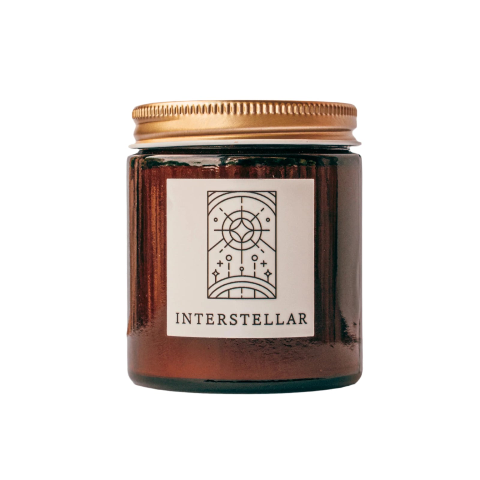 Interstellar candle in amber jar with gold lid for wholesale through Faire, Bulletin, Shoppe Object, and directly.