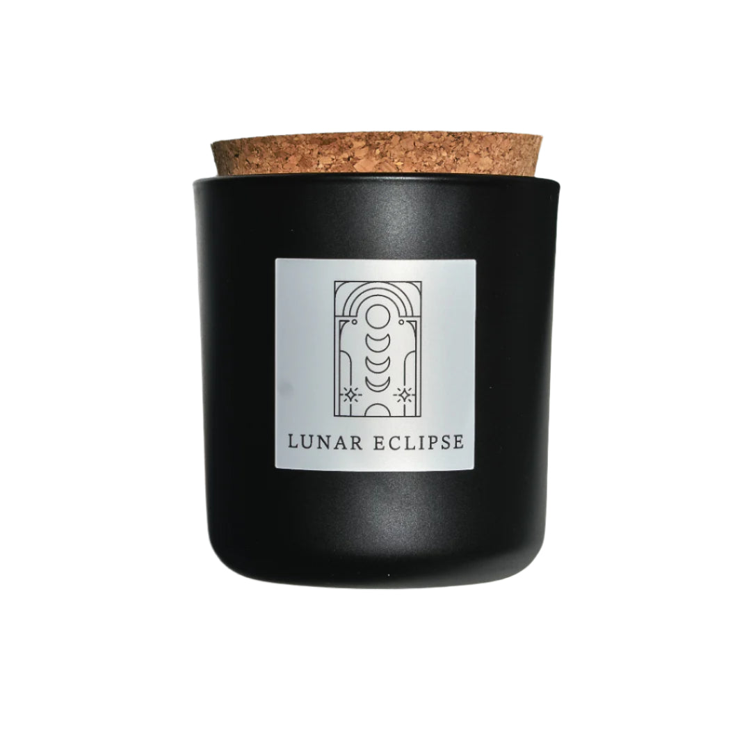 Lunar Eclipse candle in black apothecary glass with cork top for wholesale through Faire, Bulletin, Shoppe Object, and directly.